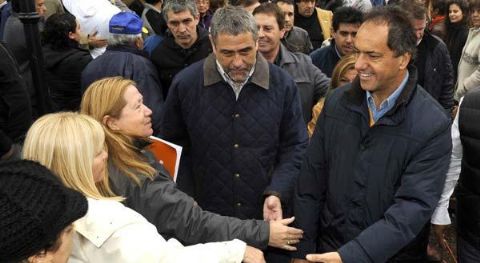Qui�n paga el costo pol�tico, una guerra aparte . Scioli este s�bado en la reinauguraci�n de un polideportivo en Avellaneda. Buena parte de su gabinete participa de la b�squeda de un acuerdo para destrabar el ajuste impositivo